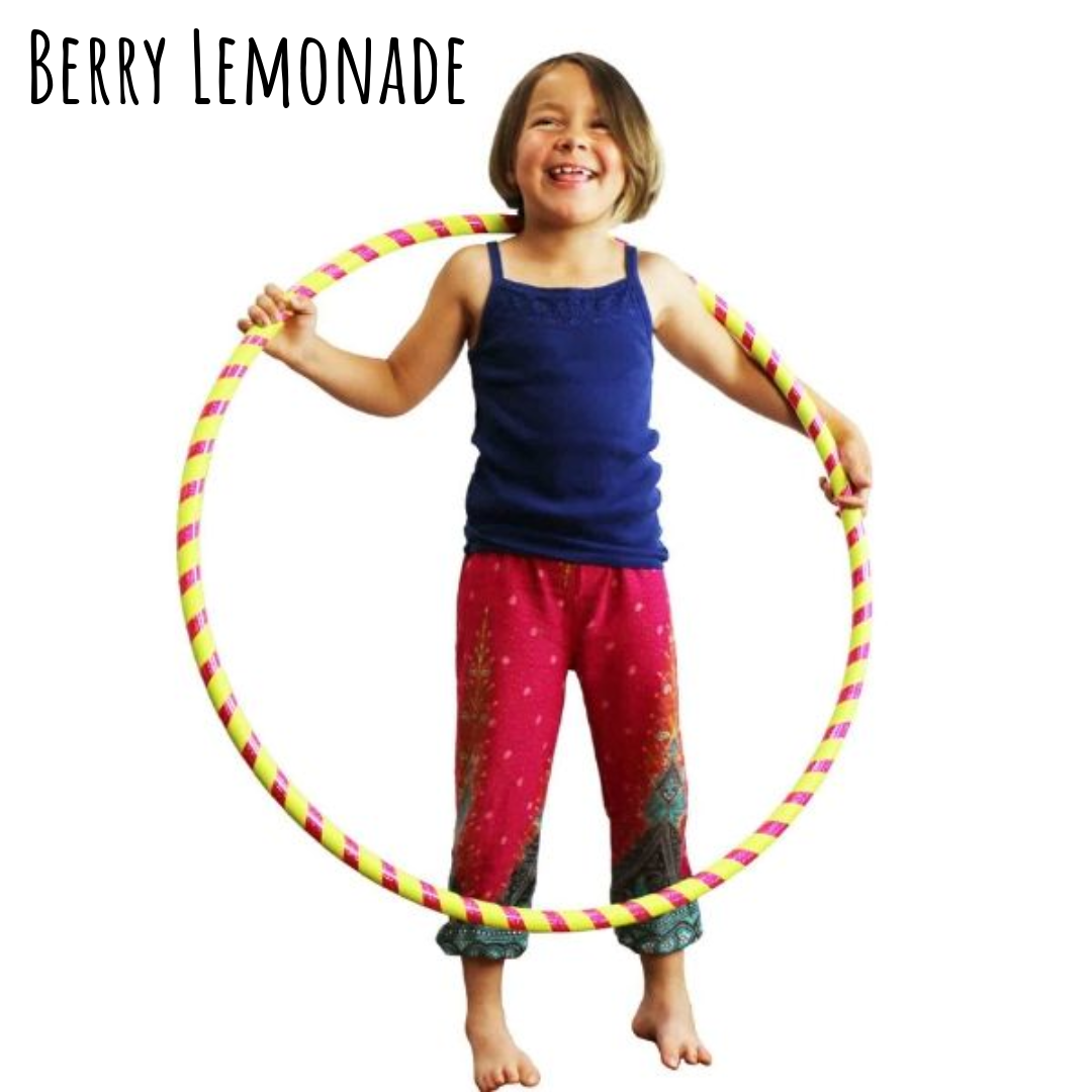 Child holding a colorful hula hoop. Berry Lemonade kids hula hoop - yellow and pink.