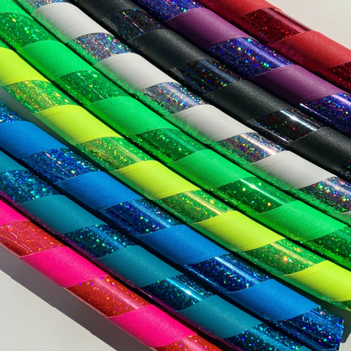 Stack of brightly colored taped kids hula hoops for a teacher class pack