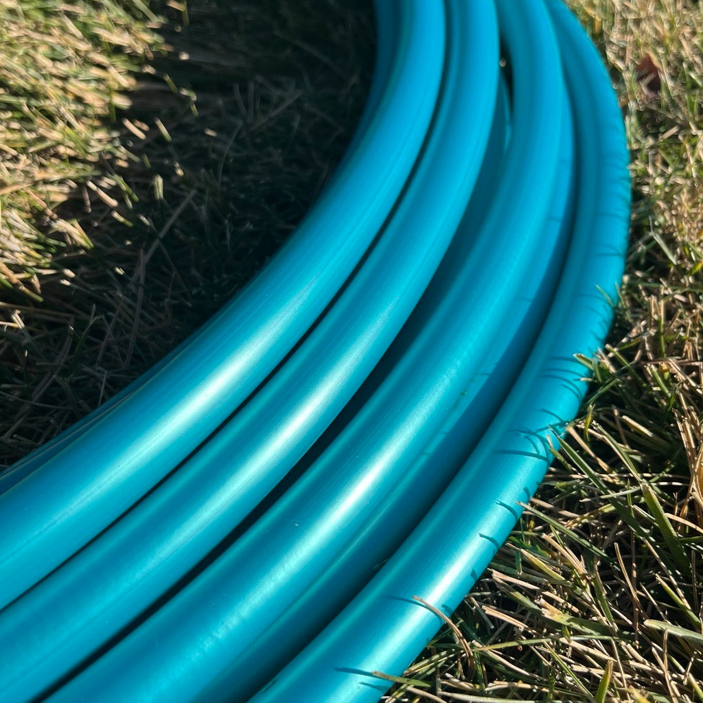 Close-up of Teal Shadow Pearl polypro hoop tubing showing its glossy shimmer.
