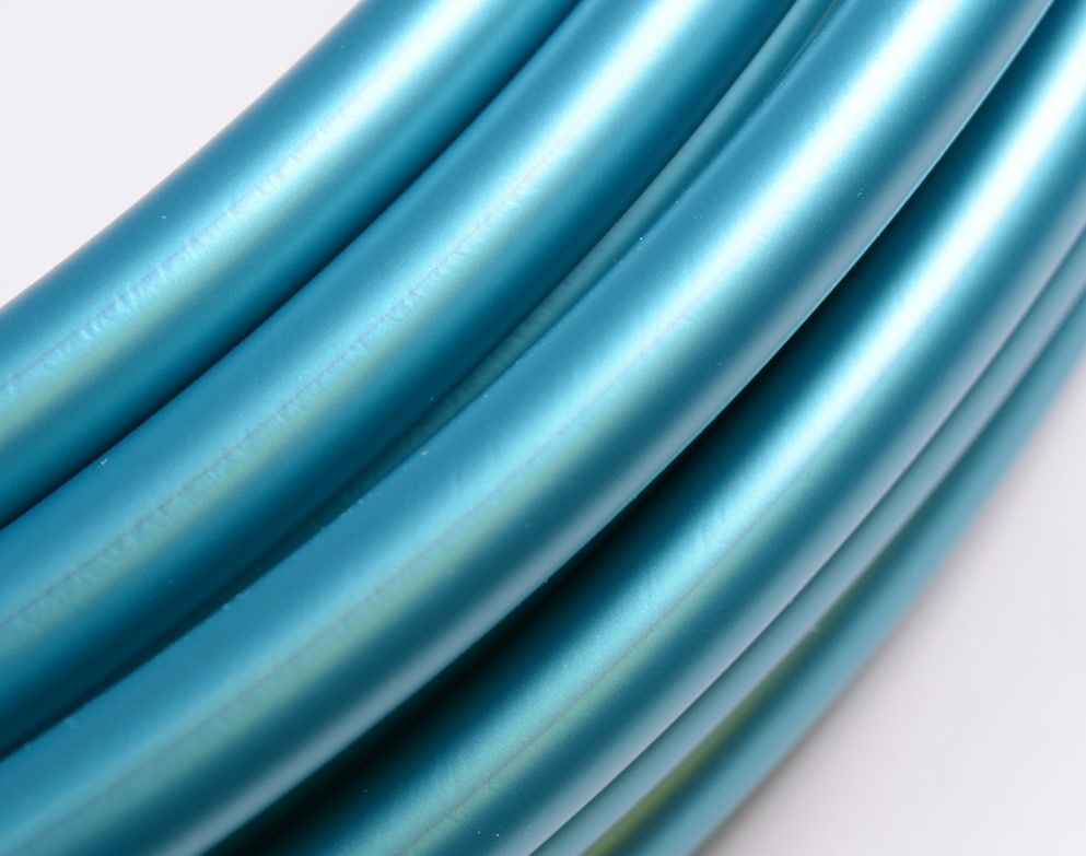 Close up of Teal Shadow Pearl Polypro Tubing with a white background. 